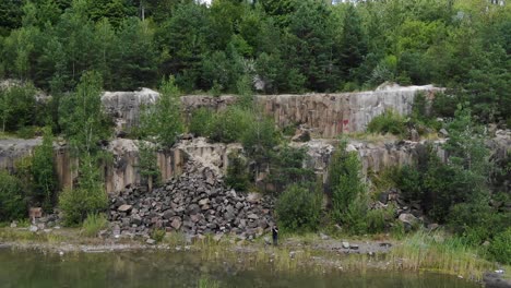 aerial view of a quarry tracking backward revealing lake with still water