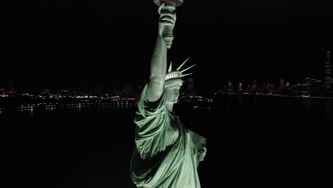 an excellent orbiting aerial view shows the upper half of the statue of liberty in new york city new york at night 1