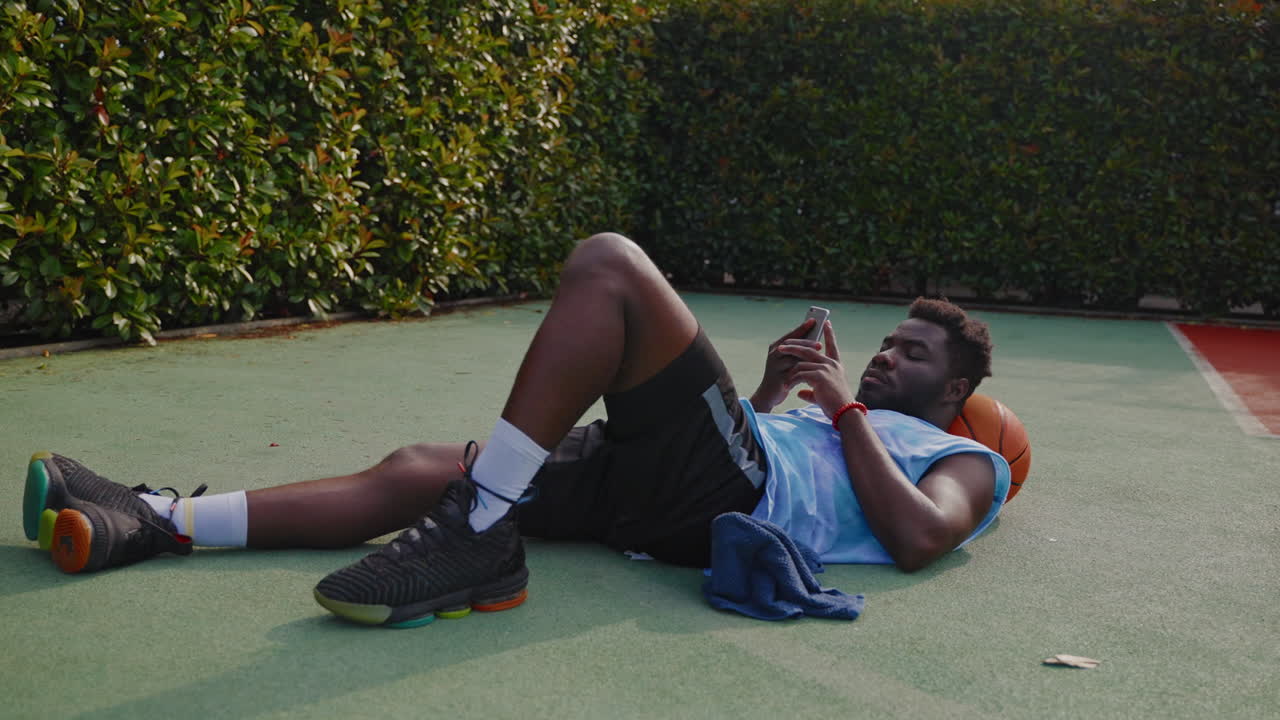 Basketball player resting on the court