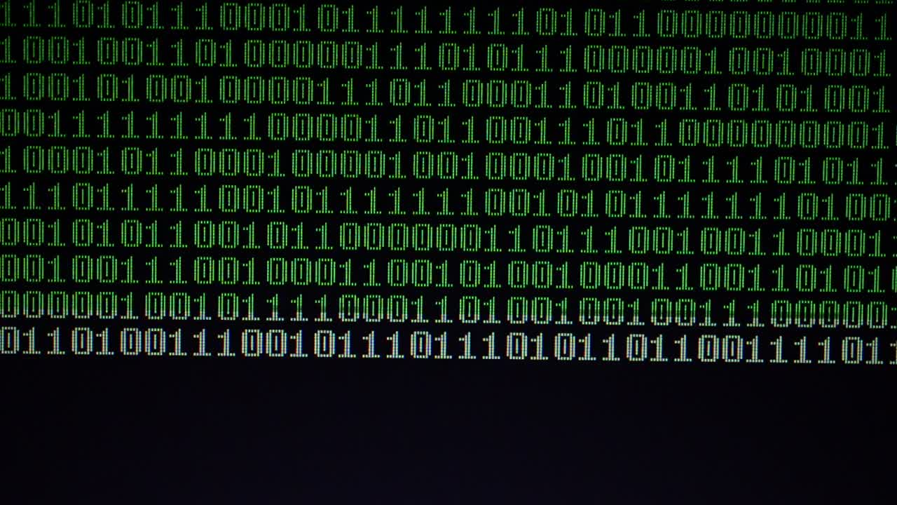 Binary code on the monitor screen. Shooting of a binary code, background