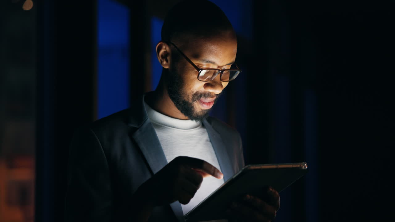 Man using tablet in the dark