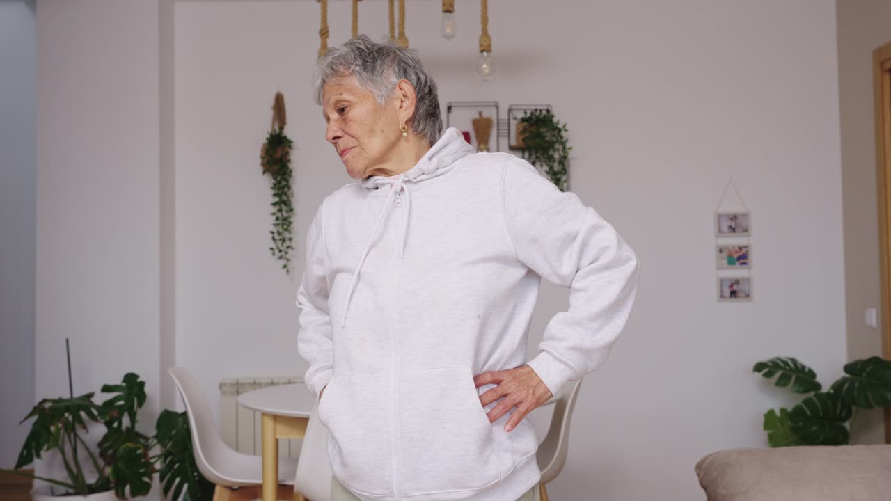 Elderly Woman Stretching and Exercising at Home