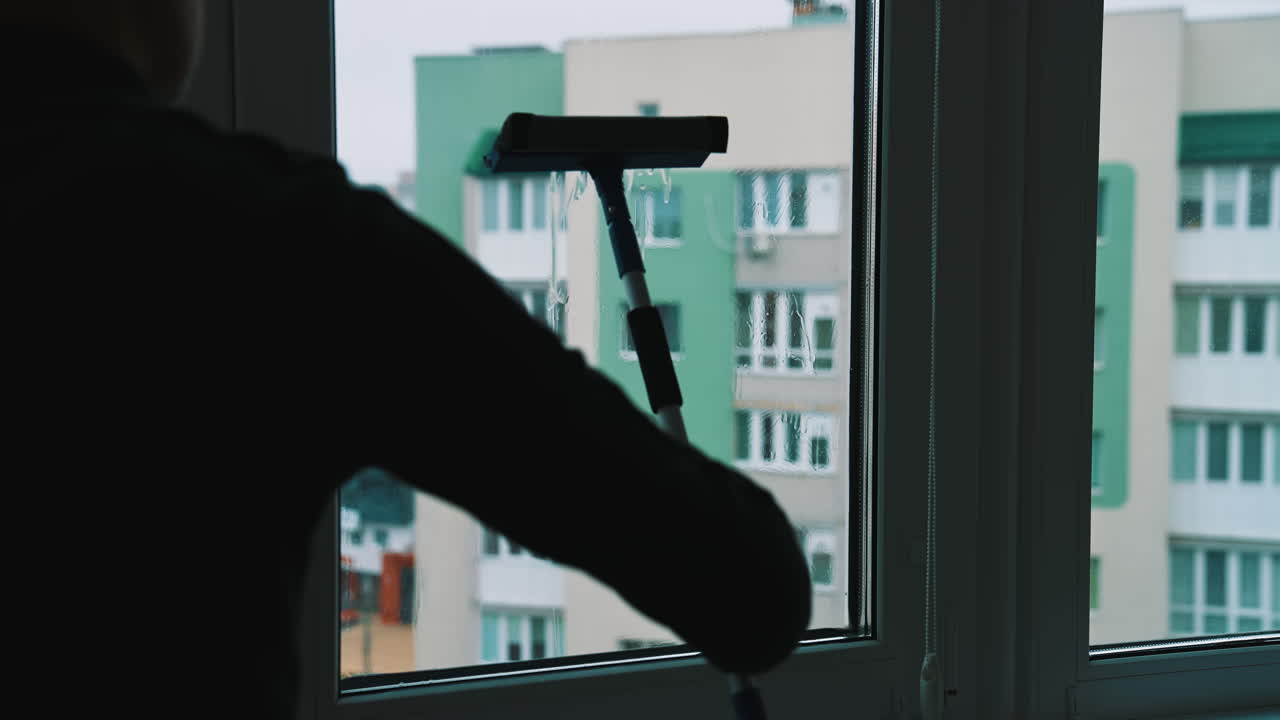 Glass cleaning professioanl worker. Window cleaning indoor interior.