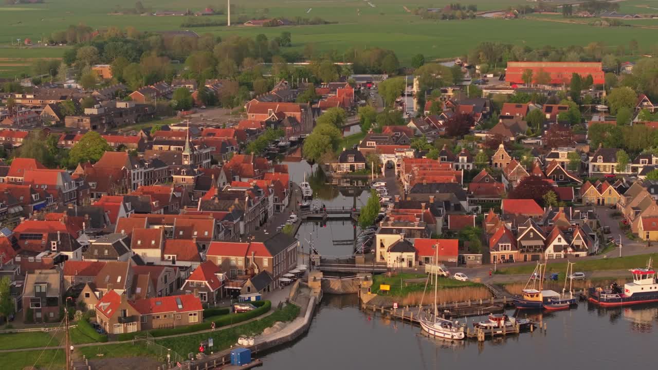 Overhead look at Makkum's rooftops, bridge, and narrow waterway