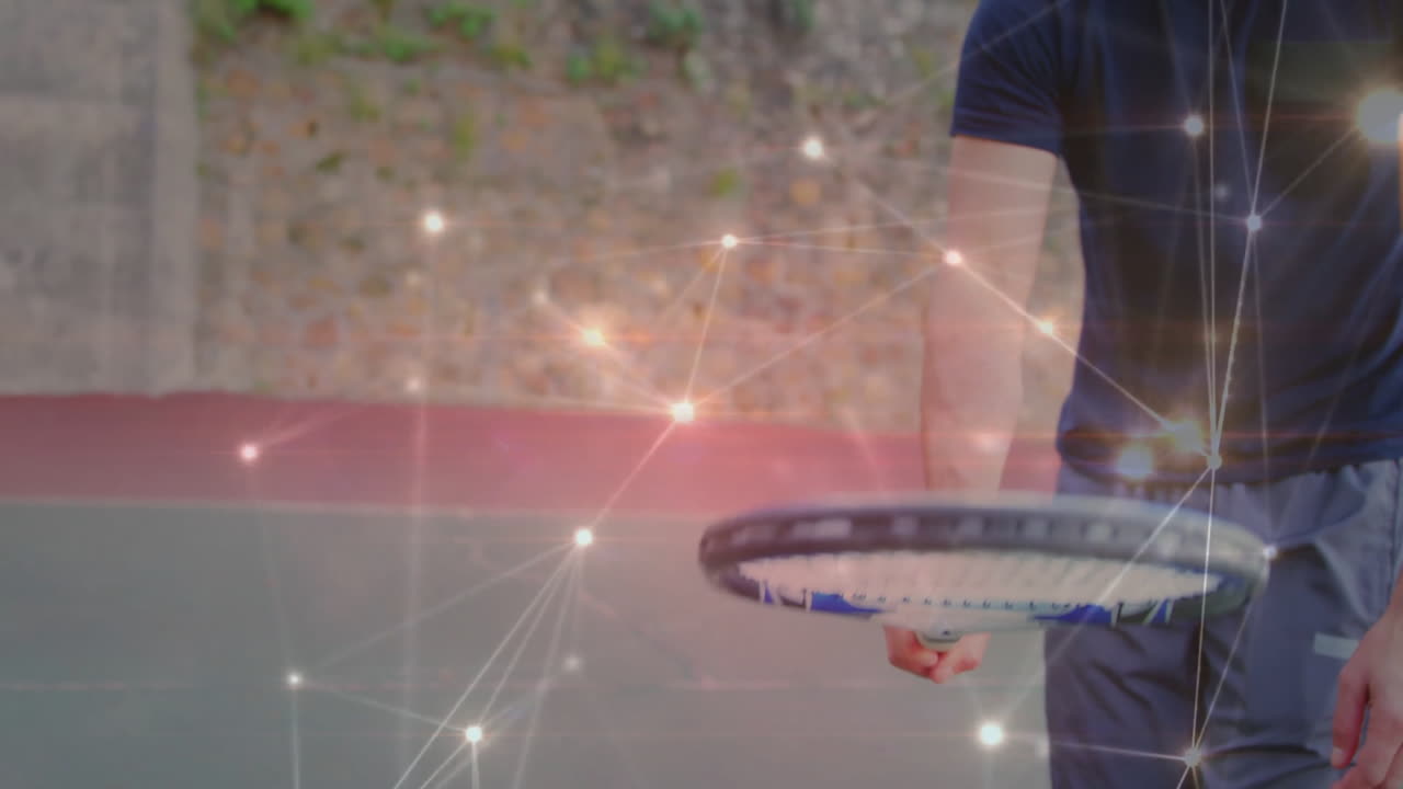 Mature male tennis player standing and holding racket on court, showing sports technology overlay
