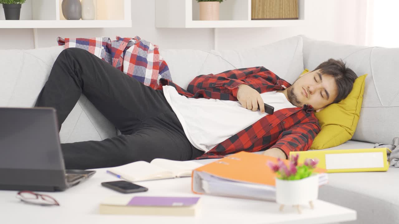 Lazy man falling asleep with tv remote in hand.