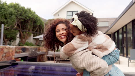 mother and daughter playing in backyard