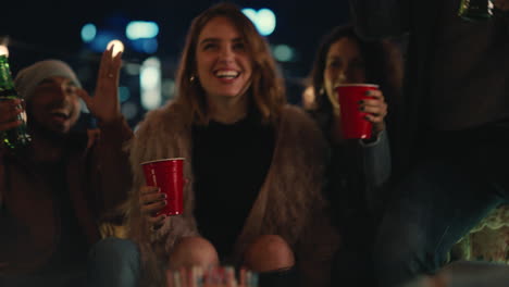 group-of-multiracial-friends-celebrating-birthday-party-on-rooftop-at-night-beautiful-young-woman-blowing-candles-enjoying-friendship-having-fun-sharing-celebration