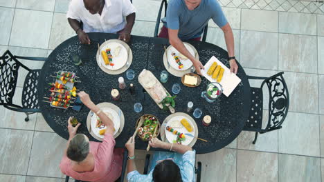 diverse friends enjoying in garden barbecue meal together, sharing food and laughter