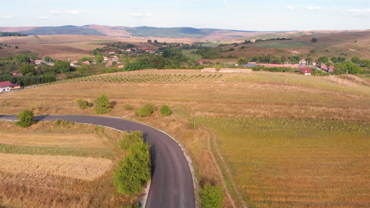 Curvy Road with small village and landscape Aerial