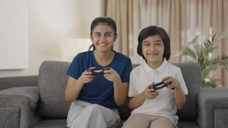 Happy-Indian-cousins-playing-video-games