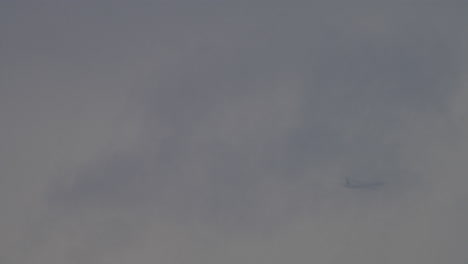 passenger airplane is flying in the clouds and fog