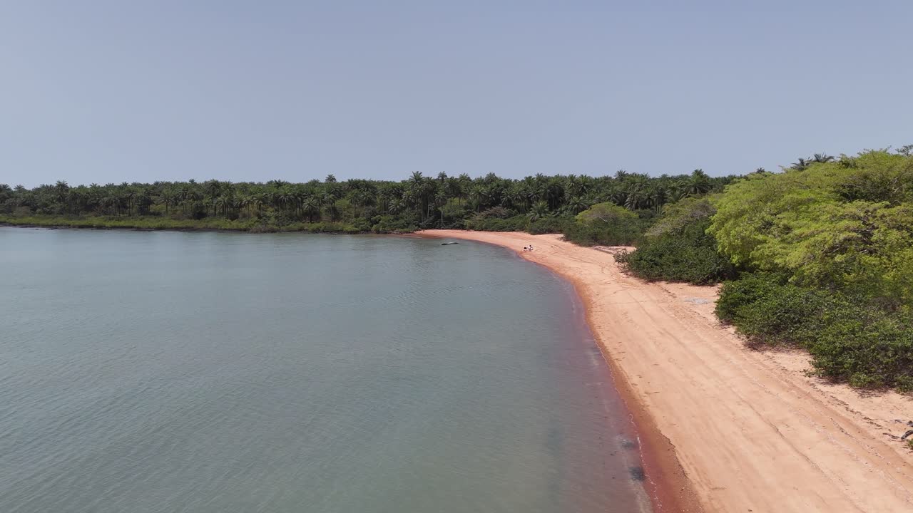 Atlantic Ocean waves rolling onto the pink sandy beach of Guinea-Bissau, West Africa’s hidden gem aerial drone footage