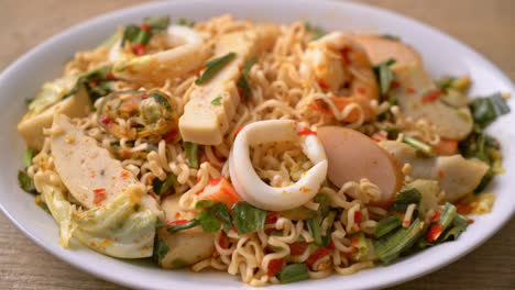 instant noodle spicy salad with mixed meats - asian food style