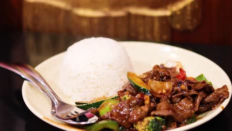 sizzling beef served with steamed rice and vegetables