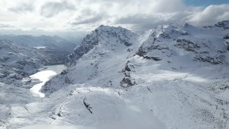 Fly-Over-drone-shot-of-a-Majestic-Mountain-Peak-in-the-Alps-from-a-Drone-in-Winter-on-a-sunny-day