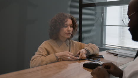 payment transaction at a counter with protective barrier