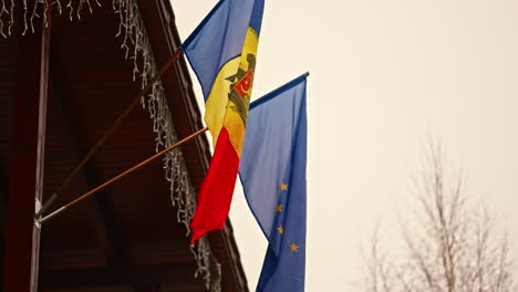 republic of moldova and europe flag attached to a home