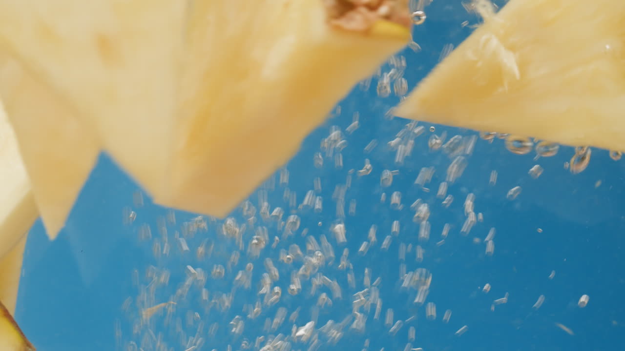 Pineapple Slices Falling into Water