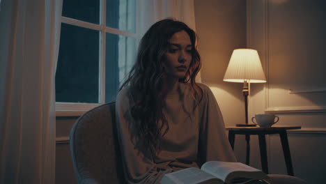 woman reading in a cozy evening setting