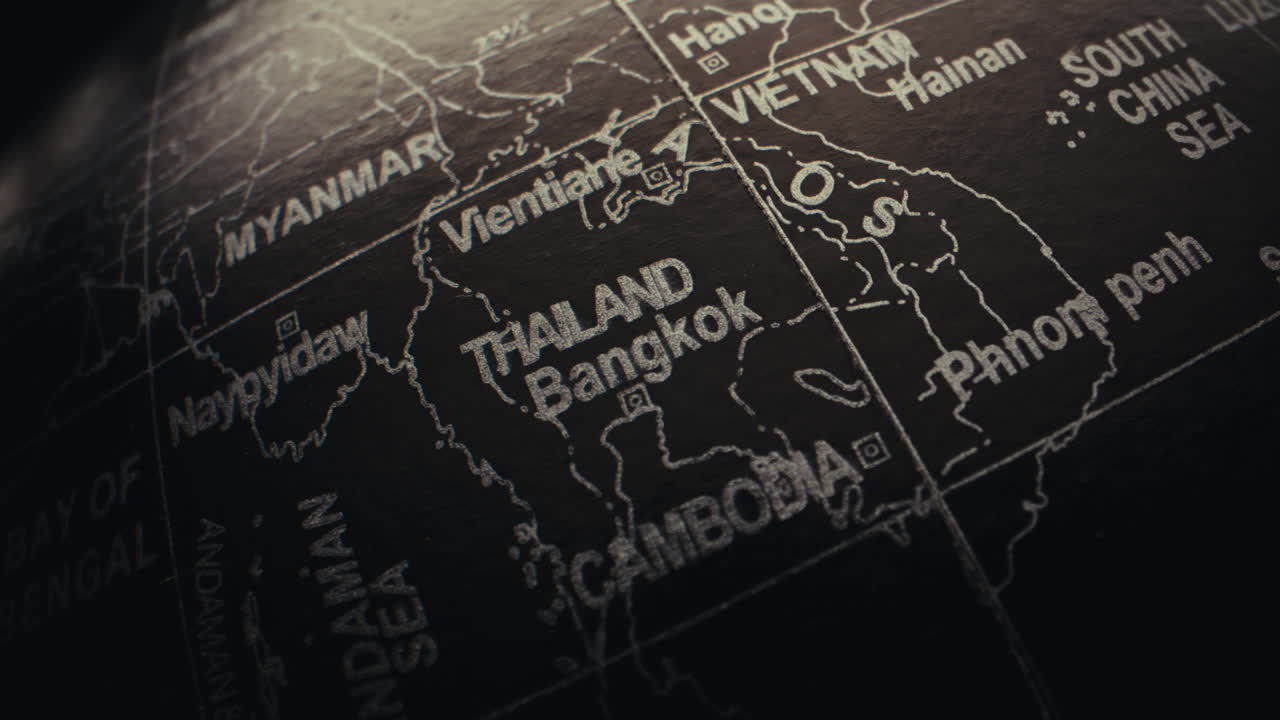 Close-up of a black globe, highlighting Thailand and Bangkok