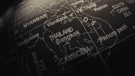 close-up of a black globe, highlighting thailand and bangkok