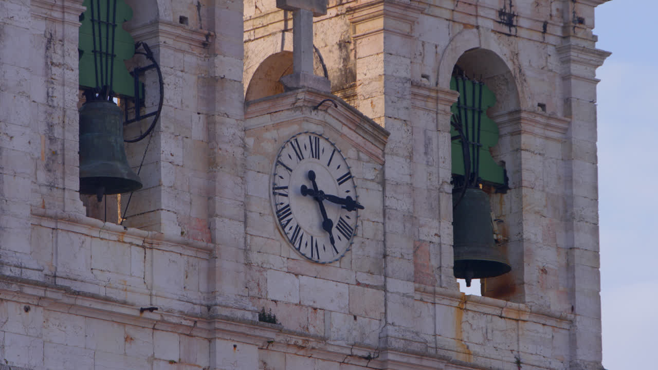 Church bells and clock in Nazare, Portugal town center above famous big wave surf break
