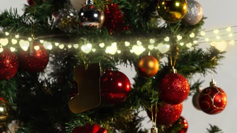 Animation-of-glowing-fairy-lights-and-christmas-tree-decorations