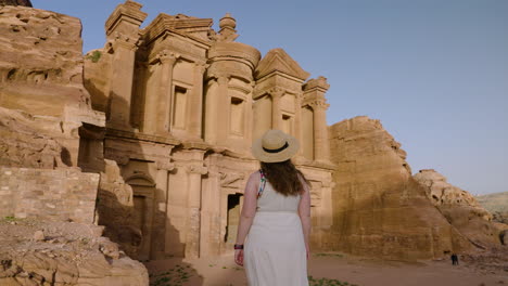 Girl-Tourist-Looking-At-The-Ad-Deir-Monastery-In-Petra,-Jordan---Pullback