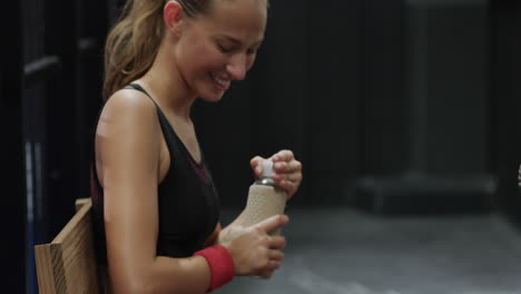 young woman in sportswear relaxing after padel tennis match, looking content, on indoor court