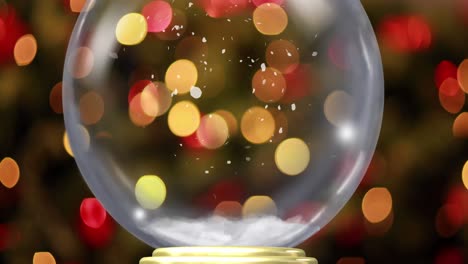 animación del globo de nieve de navidad con nieve cayendo con luces de hadas parpadeantes en el fondo