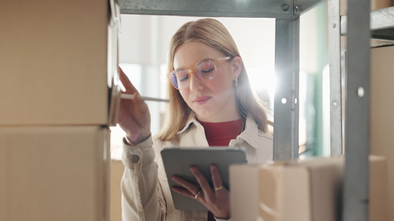 Woman using tablet in warehouse checking inventory