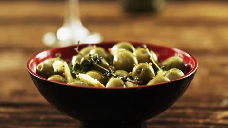 bowl of green olive tapas and wine