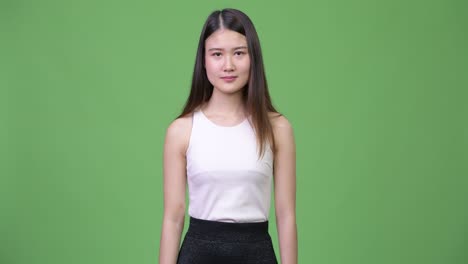 young beautiful asian businesswoman pointing to camera