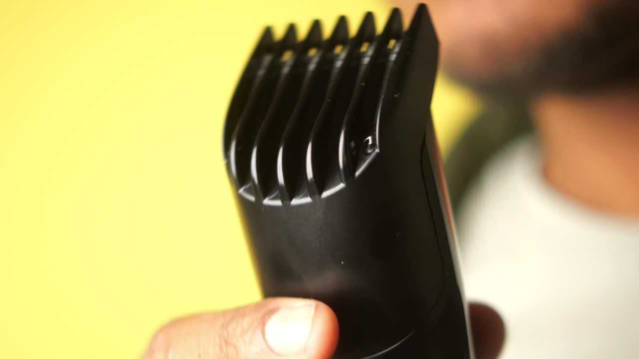 Close-up of a handheld hair clipper in a hand