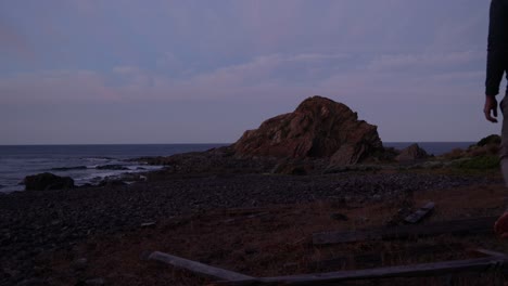 A-man-looking-at-a-wild-Australian-ocean-while-camping