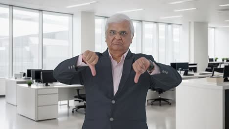 angry indian senior manager showing thumbs down