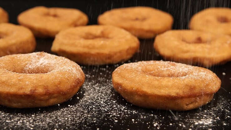 DOLLY: A sugar powder falling on a doughnuts
