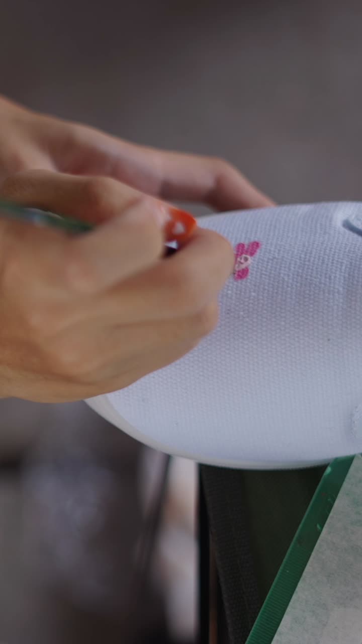 Hand painting floral design on a shoe