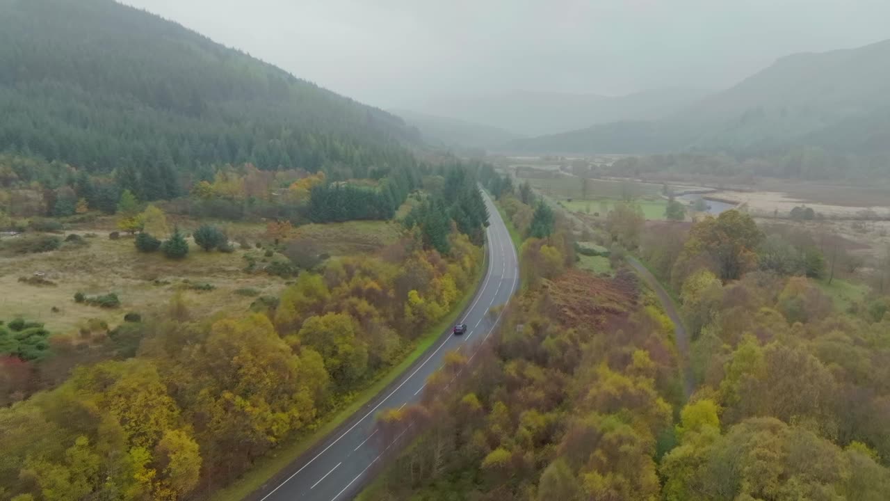 Remote road through Scottish Highlands, aerial shot on cloudy day