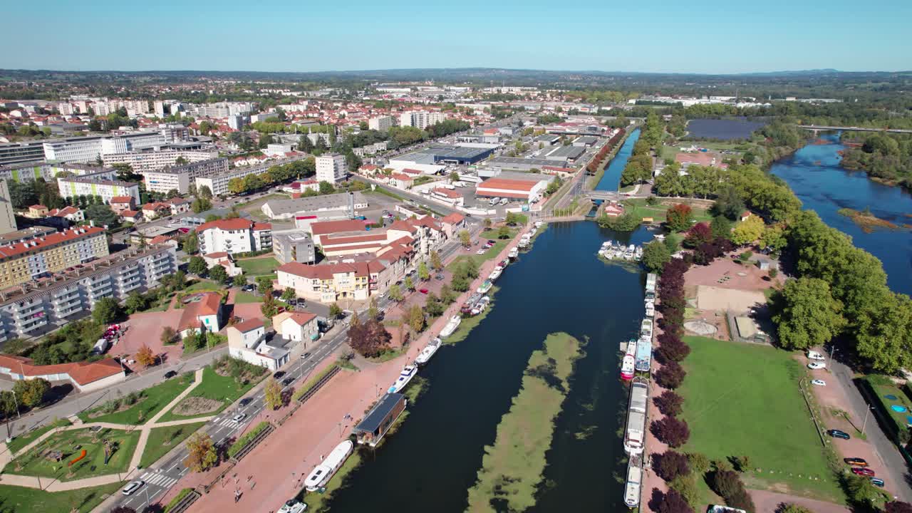 aerial shot revealing Roanne city Harbor and the Roanne Digoin canal on a sunny day in Loire departement, Auvergne Rhone Alpes region, France