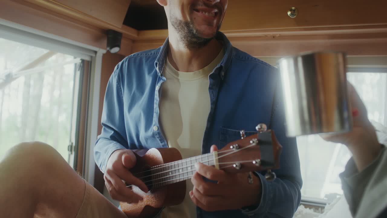 una pareja tocando el ukulele en una camioneta