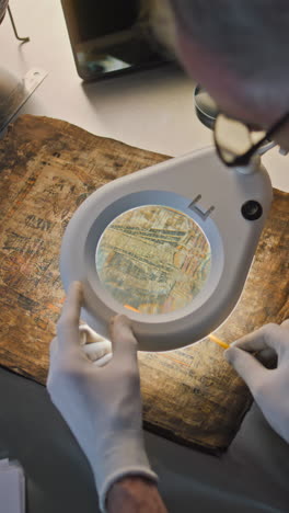 researcher examining an ancient manuscript