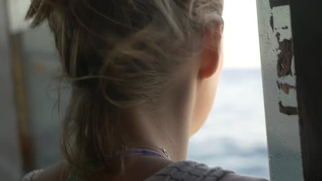 CU-of-Woman-Looking-Out-of-Boat-Window