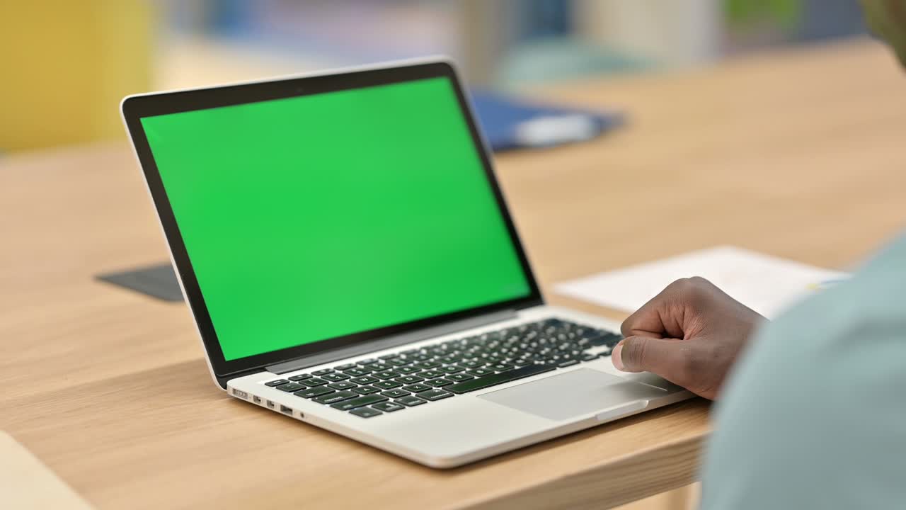 African Man Using Laptop with Chroma Screen