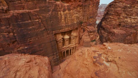 the treasury at petra, historic unesco heritage site carved into sandstone in jordan seen from a scenic viewpoint above and sideways. famous indiana jones hollywood movie filming location and tourist destination khaznet.