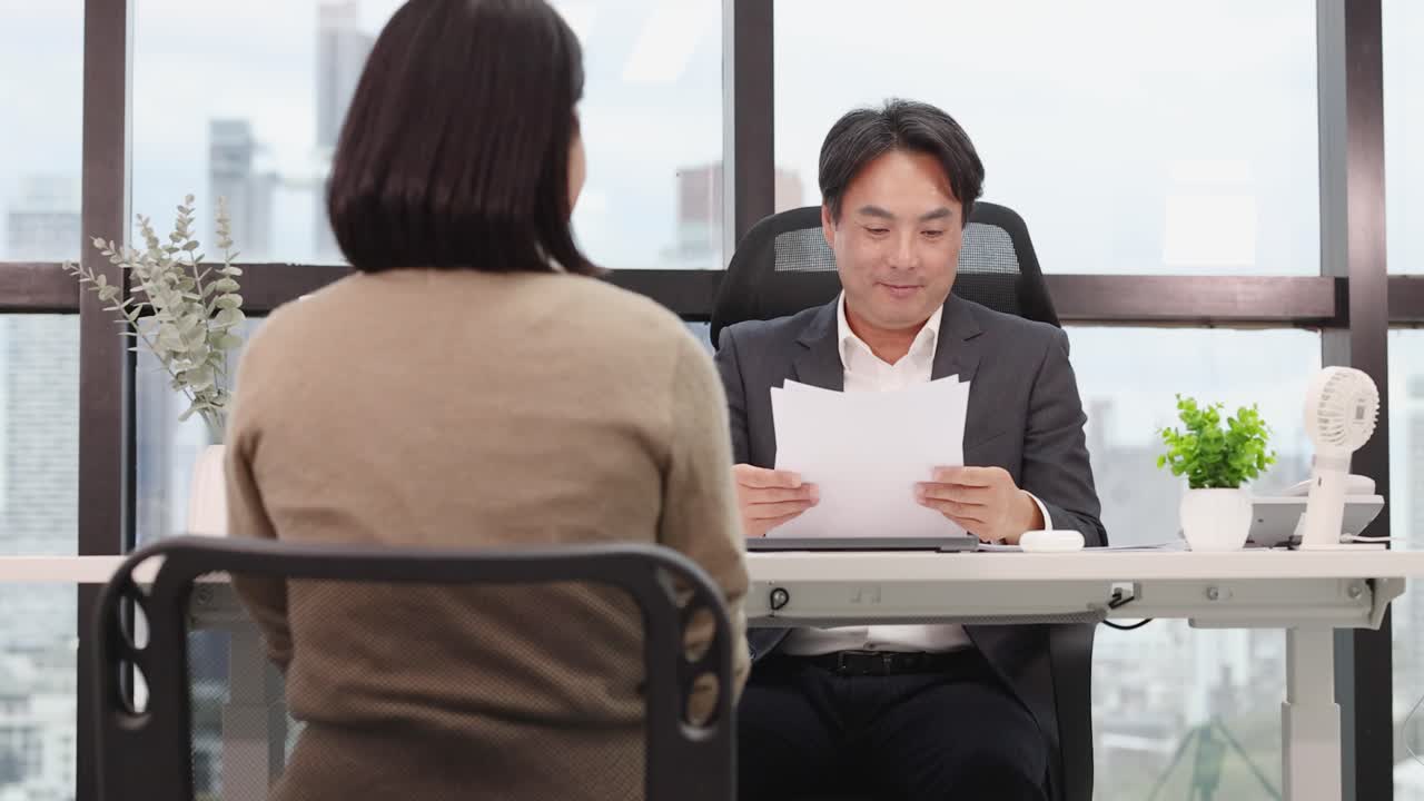 Businessman interviews candidate in bright office, natural daylight ...