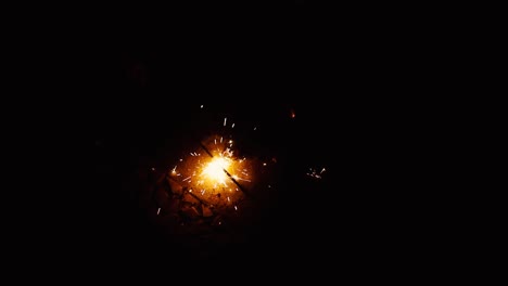 preparing sparkle cracker end isolated on a black background in slow motion