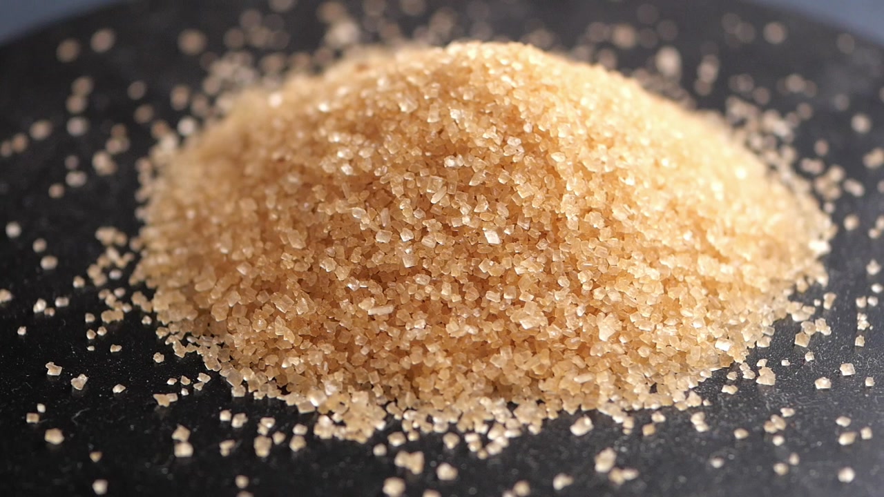 Close-up of Brown Sugar Crystals on a Dark Background