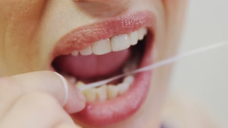 female patient flossing her teeth